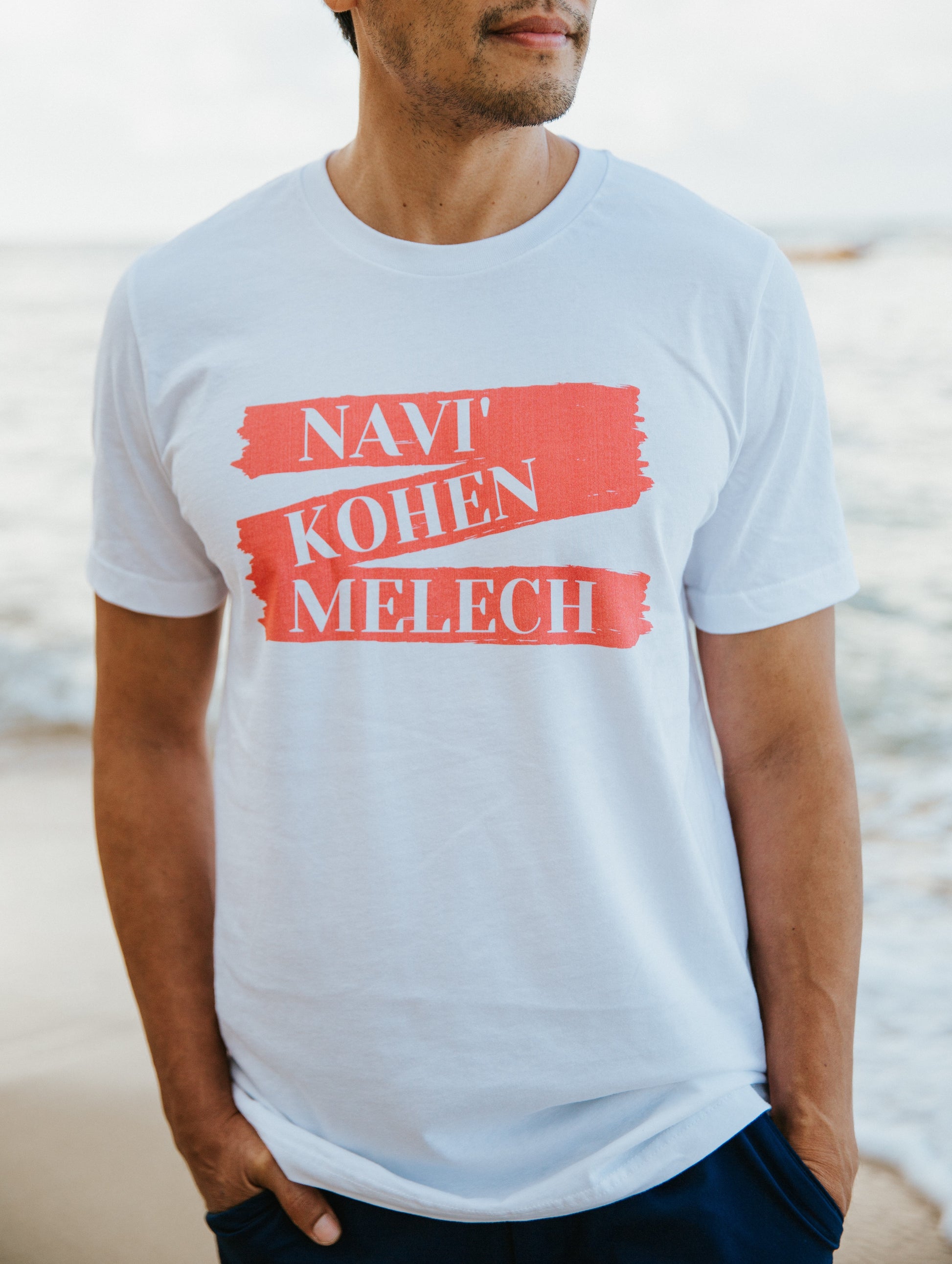 Men's T-Shirt from Terse Verse, a Christian apparel brand. The t-shirt is white and features the words "Navi', Kohen, Melech" (prophet, priest, king) in white lettering on a red banner graphic.