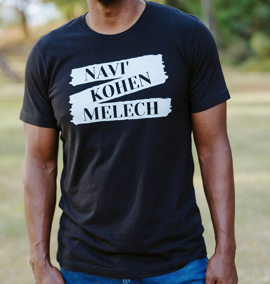 Men's T-Shirt from Terse Verse, a Christian apparel brand. The t-shirt is black and features the words "Navi', Kohen, Melech" (prophet, priest, king) in black lettering on a white banner graphic.